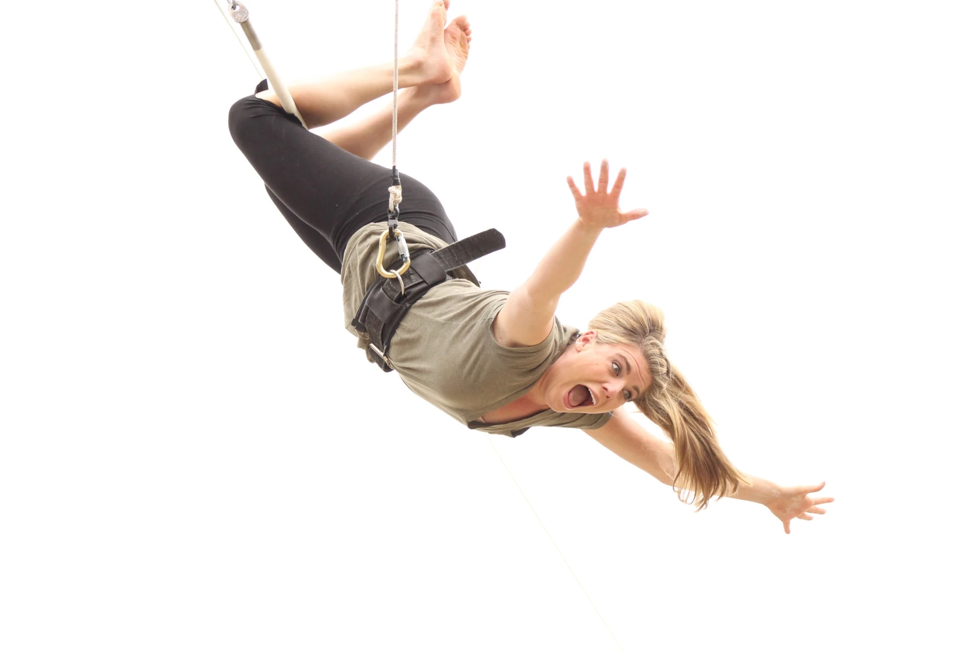 Flyer swinging horizontally on the flying trapeze at Dallas Circus Center