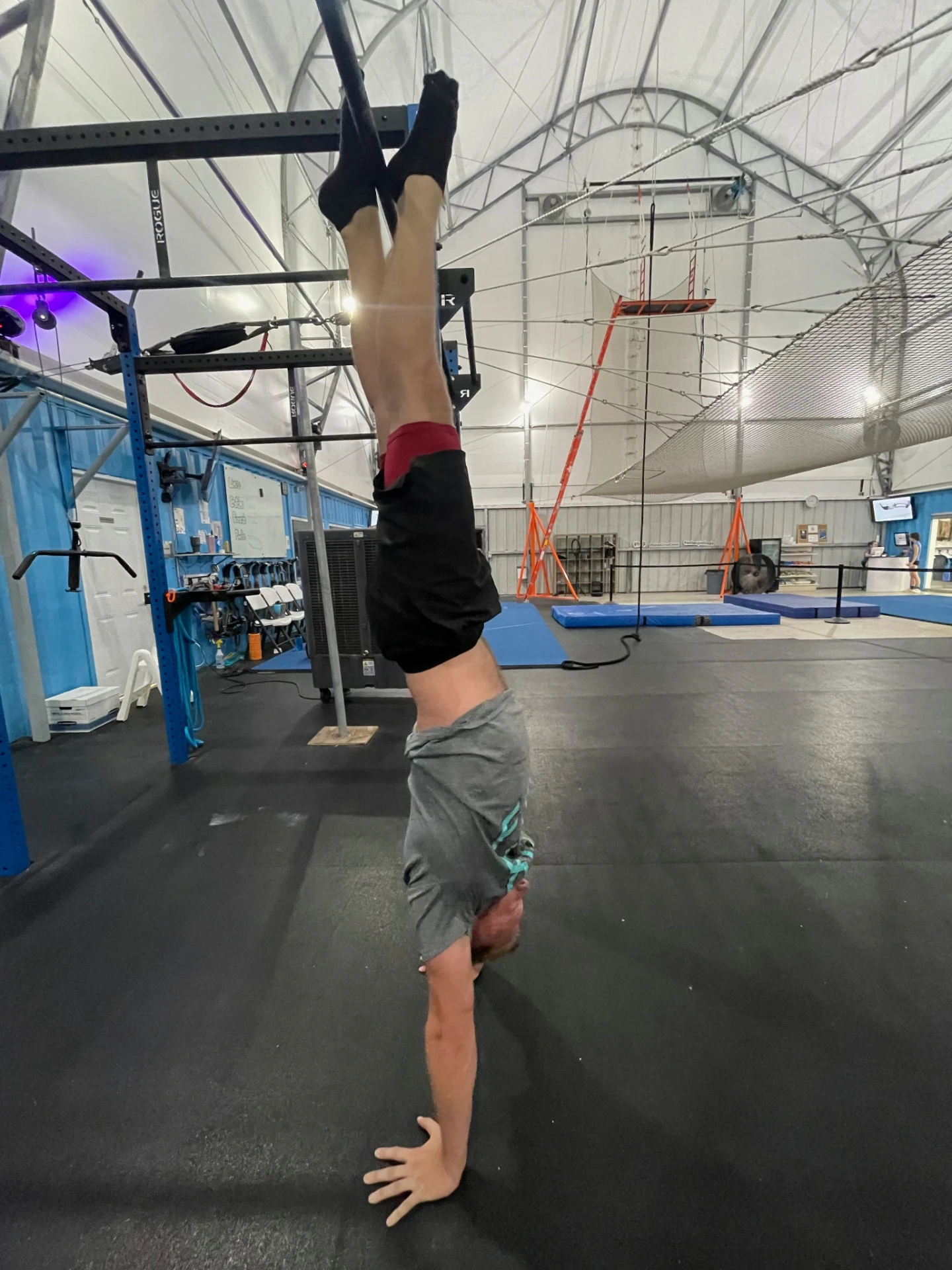 Student balancing upside down during handstand training at Dallas Circus Center