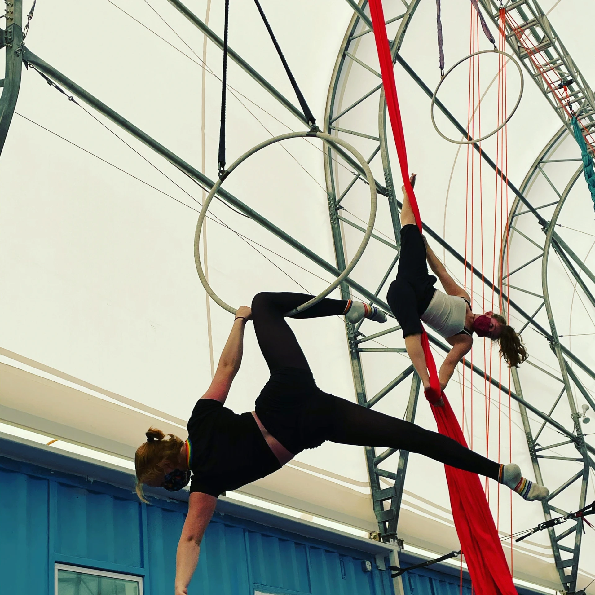 Aerialists posing on suspended lyra hoops at Dallas Circus Center